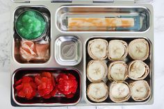 an open lunch box filled with food and chopsticks on top of each other