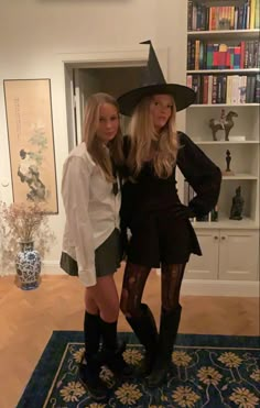 two women dressed up as witches posing for the camera