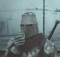 a man dressed as a knight holding a cell phone