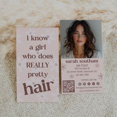 a hair salon business card sitting on top of a fur rug