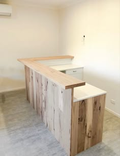 an empty kitchen with a wooden counter top