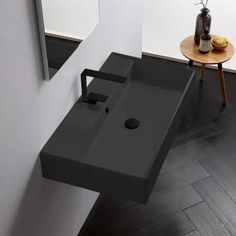 a bathroom sink sitting on top of a wooden floor