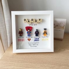 a wooden scrabble frame with the words daddy you are surrounded by legos