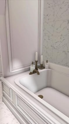 a white bathroom sink sitting under a mirror next to a bath tub with candles on it