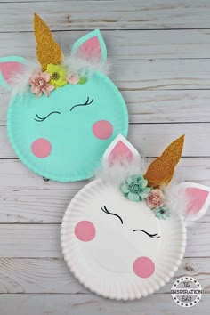 two paper plates with unicorn faces and flowers on them, one has a flower in its hair