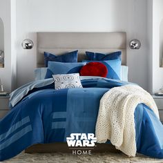 a star wars themed bedroom with blue and red bedding, comforter, pillows and blankets