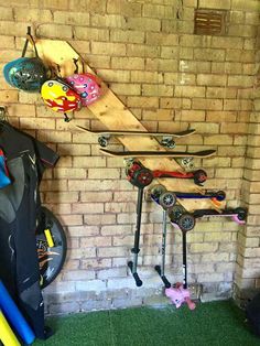 there are many snowboards and skis hanging on the wall