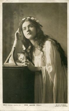 an old black and white photo of a woman holding a tea cup in her hand