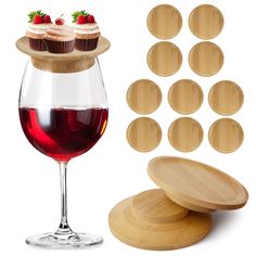 cupcakes and wine are sitting on wooden coasters next to a glass of red wine