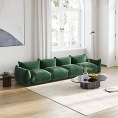 a living room filled with furniture and a large painting hanging on the wall above it