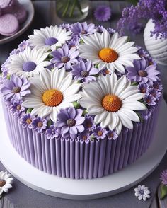 a cake decorated with purple and white flowers