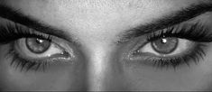 the eyes of a woman with long lashes and false eyelashes are shown in black and white