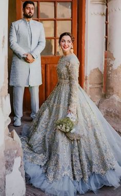 a man standing next to a woman in a wedding dress