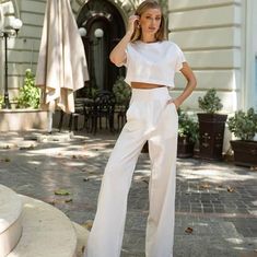 Elevate your summer wardrobe with this sophisticated two-piece linen set, featuring a chic crop top and high-waisted wide-leg pants in a stunning milk white shade. Perfect for warm weather, this breathable and stylish outfit is ideal for both casual and dressy occasions.          Material: 100% linen, offering a natural and breathable feel        Color: Milk white, a versatile and timeless shade        Sizes: Available in XS, S, M, L to ensure the perfect fit        Minimalist design with a rela White Crop Top For Summer Workwear, White Crop Top For Workwear In Summer, Elegant Linen Wide Leg Pants For Day Out, Elegant High Waist Wide Leg Pants For Vacation, Summer Wide Leg Linen Pantsuit, Chic Two-piece Spring Pantsuit, Wide Leg Linen Pantsuit For Summer, Chic Summer Wide-leg Pantsuit, Summer Solid Color Straight Pantsuit