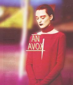 a man in a red shirt with an arrow on his chest and the words ann avox above him