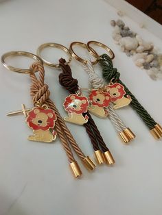 four key chains with flowers and hearts on them