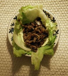 lettuce with mushrooms in it on a plate