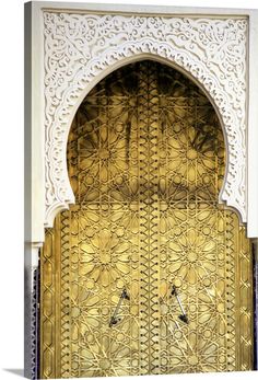 an ornate gold door with two birds on it