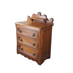 an antique wooden dresser with drawers and knobs