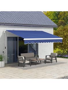 an awning on the outside of a house with patio furniture and potted plants