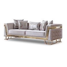 a white couch with gold trimmings and pillows on the back, sitting against a white background