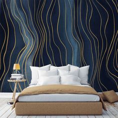 a large bed sitting in front of a blue wall with gold lines on the walls