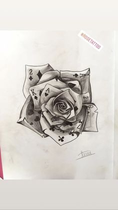 a pencil drawing of a rose with playing cards on it's petals and an eye in the center