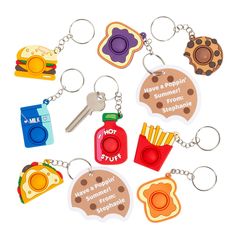 several different shaped key chains with some food on them and one has a sandwich, hot dog, french fries, ketchup, cheeseburger