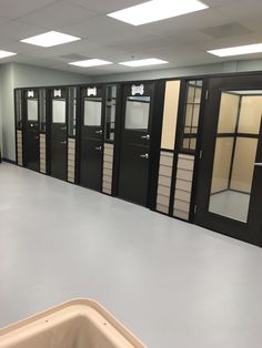 an empty room with lots of cabinets and drawers on the walls in front of them