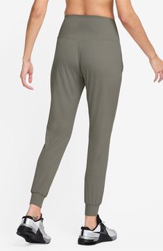 Legging-inspired joggers are made from soft fabric that you can feel with every bend or stretch, while moisture-wicking technology keeps you cool and comfy. 27 1/2" inseam; 8" leg opening; 13 1/2" front rise; 14" back rise (size Medium) Pull-on style Front slant pockets Lined gusset Dri-FIT moisture-wicking technology 63% nylon, 37% spandex Machine wash, line dry Imported Nike Joggers With Ribbed Waistband For Jogging, Yoga Sportswear Joggers With Relaxed Fit, Relaxed Fit Joggers With Ribbed Waistband For Yoga, Relaxed Fit Go-dry Joggers, Workout Joggers With Ribbed Waistband And 4-way Stretch, Nike Solid Color Athleisure Joggers, Nike Sporty 4-way Stretch Bottoms, Nike Joggers For Loungewear, Solid Athleisure Activewear With Elastic Cuffs