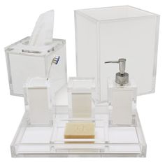 clear bathroom accessories including soap, toothbrush and tissue dispenser on white background