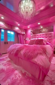 pink bedroom with chandelier and fluffy bedding