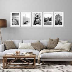 three black and white photographs hang on the wall above a couch in a living room