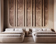 two beds sitting next to each other in front of a wall with carved wood panels