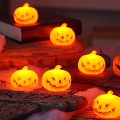 carved pumpkins glowing in the dark on display