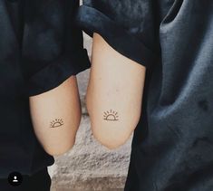 two people with small tattoos on their feet, one is holding the other's leg