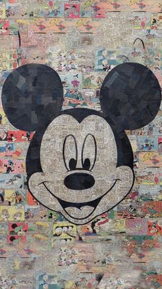 a mickey mouse made out of old newspaper paper with the word disney on it's face