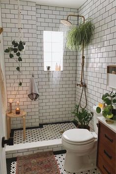 a white toilet sitting next to a shower in a bathroom