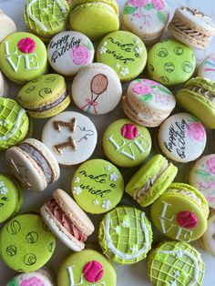 there are many decorated macaroons on the plate