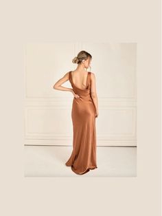 a woman in a brown dress is looking back