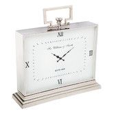 a white clock sitting on top of a metal stand