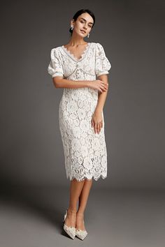 This lace crochet V-neckline midi dress will fill any of your little white dress needs, from your bridal shower to your after party. The textured lace overlay, accented with thick embroidery that outlines the lace’s blooms. Also features puff sleeves and delicate scalloped eyelash lace hem. The rhinestone trim and buttons adds an extra glitz and glam. No Stretch Medium Weight Size runs small,recommend one size up Fabric: 100% Polyester,Lining: 100% Polyester Model is 174cm/5'7" tall, 81cm/32" bust, 61cm/24" waist and 90cm/35" hip and wears a size S. Care Instruction: Hand Wash, Do not bleach, Dry flat in shade, Iron cool (max 110â„?, Dry clean, tetrachloroethylene(PCE) only.Please note: The images represent actual product though color of the image and product may slightly differ. This item Spring Formal Midi Dress With Lace Bodice, Delicate Lace V-neck Dress For Brunch, Evening Lace Midi Dress With Scalloped Details, Elegant Knee-length Lace Dress, Elegant Midi Dress With Delicate Lace For Party, Elegant Party Midi Dress With Delicate Lace, Lace Top Midi Dress For Evening, Elegant Midi-length Crochet Dress With Scalloped Lace, Feminine Formal Midi Dress With Scalloped Lace