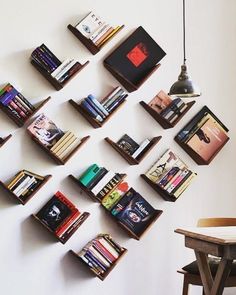 the bookshelves are arranged on the wall to form a triangle, and each shelf is filled with different types of books