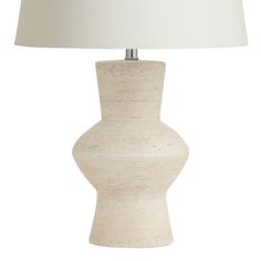 a white table lamp with a beige shade