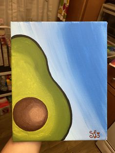 an avocado painted on a canvas in a kitchen