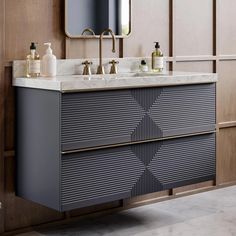 a bathroom vanity with two sinks and a large mirror above it, in front of a wooden paneled wall