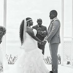 a bride and groom holding hands during their wedding ceremony