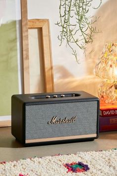 a radio sitting on top of a table next to a vase