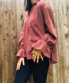 Gorgeous striped top, in a color that is perfect for fall! We love the high/low hem and gathered tie sleeves. The fit is true to size and generous. This is a top that is perfect for work or play. Casual Vertical Stripes Blouse For Fall, Fitted Striped Blouse For Fall, Relaxed Fit Long Sleeve Tops With Tie Sleeves, Spring Long Sleeve Blouse With Vertical Stripes, Relaxed Fit Striped Tops For Fall, Fitted Tops With Vertical Stripes For Fall, Fitted Vertical Stripes Top For Fall, Fall Striped Fitted Blouse, Vertical Stripes V-neck Tops For Workwear