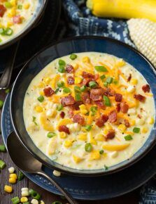 two bowls of corn chowee with bacon and green onions